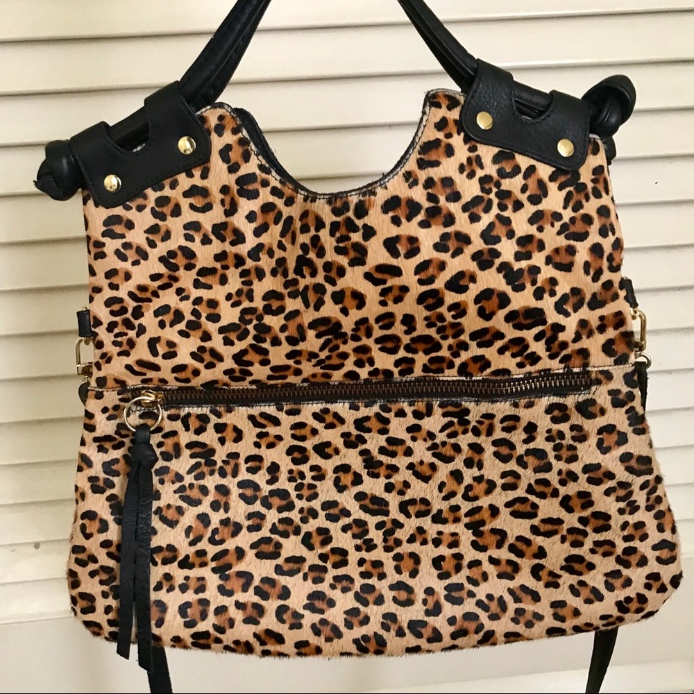 Calf hair leopard purse with leather accents.